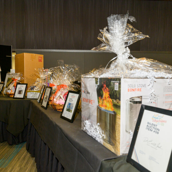 The silent auction prize table at the 203 Laughs _ Libations event.