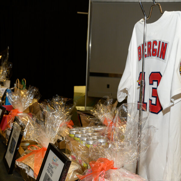 A photo of the silent auction table at the 2023 Laughs + Libations event.