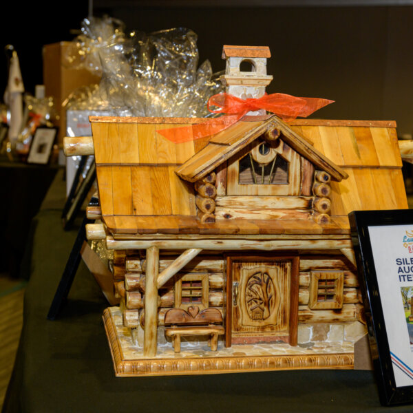 A gorgeous hand-carved birdhouse that was a prize at the 2023 Laughs + Libations event.