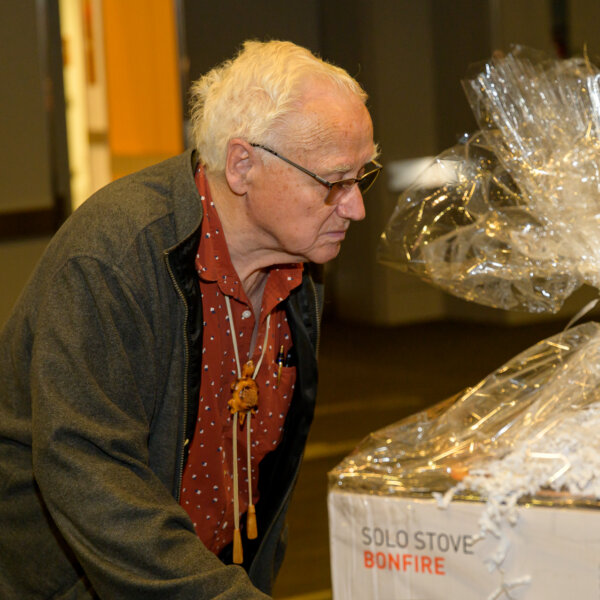 A man checks out the silent auction prize table.