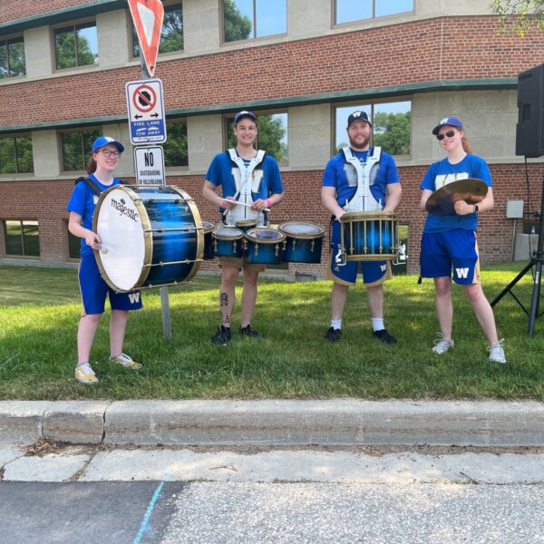 Four members of the Bombers marching band at the start line.
