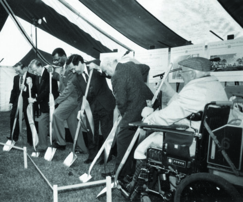 6 Men - one in a wheelchair - break ground on the construction of the new hospital at Riverview Health Centre. The photo was taken in September of 1992. 